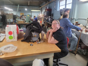 Woman at a workbench at the Grange, sorting specimens