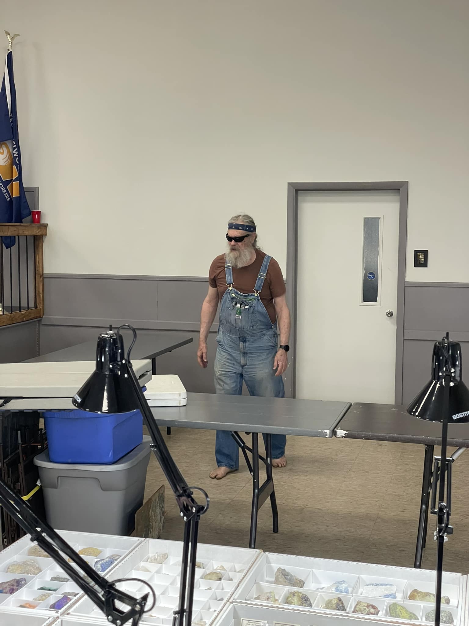 Portrait of Hank Pulaski, bearded and in overalls at the Grange meeting hall
